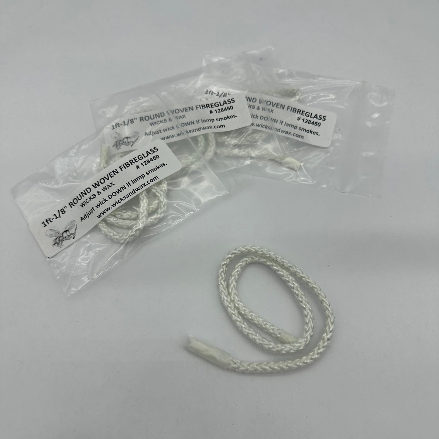 White fibreglass wick on white background with packaged fibreglass wicks