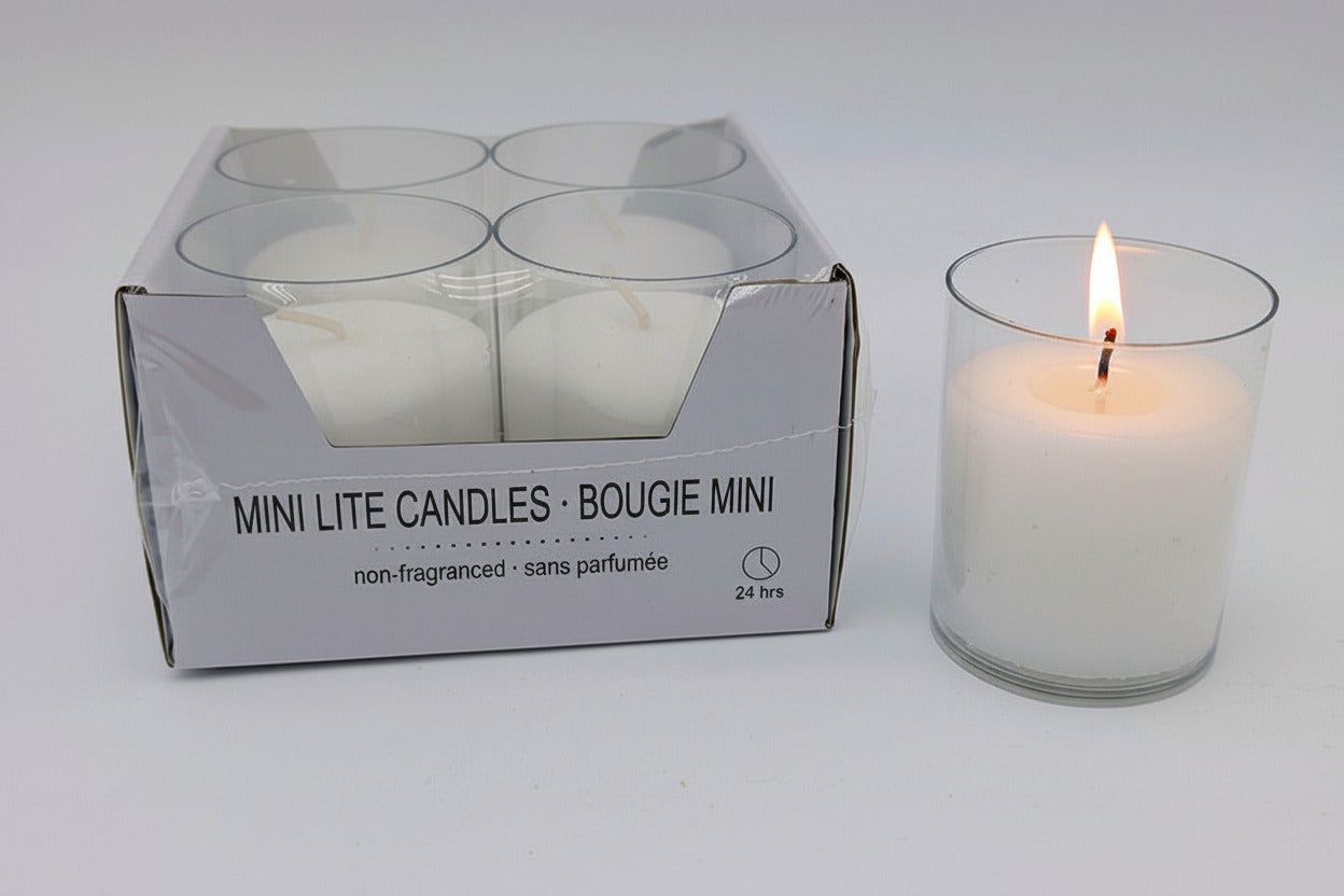 Box of Mini Lite Candles with one candle lit on a white background
