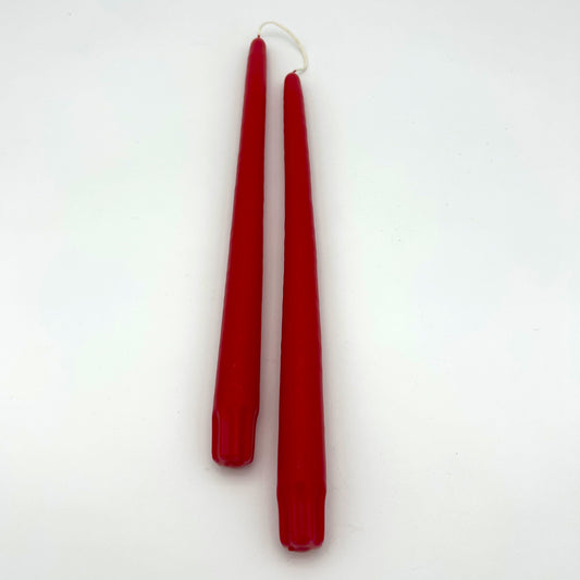 Two red candles on a white background
